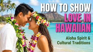 Couple wearing leis smiling on a Hawaiian beach, representing aloha love and connection